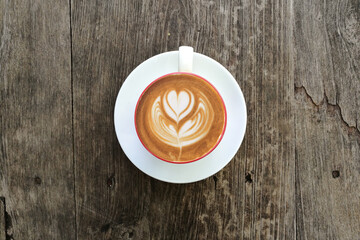 a cup of latte art coffee on wooden background                                                                                                                                                          
