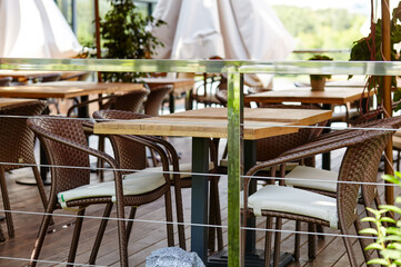 Fototapeta na wymiar Restaurant terrace umbrella with light lamp bulbs. Modern exterior of summer cafe. Blurred image, selective focus