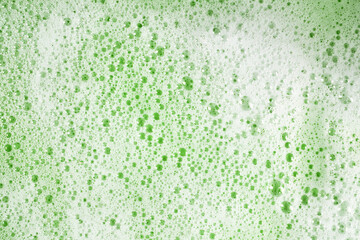 soap foam on green foch texture background backdrop