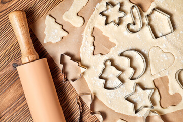 Making gingerbread Christmas Cookies Using form for cooking on wooden background