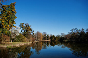 Fototapeta na wymiar Pond in Lednice with beautiful gardens and parks on sunny autumn day in South Moravia, Czech Republic, Europe.