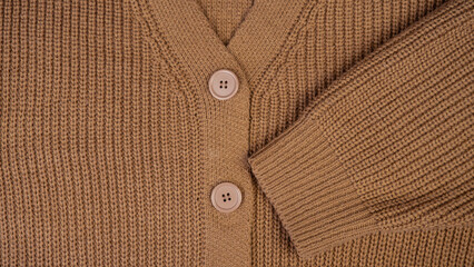 Texture of woolen knitwear.Natural woolen fabric, sweater fragment.Knitted pattern close-up.