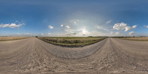 Fototapeta na wymiar full seamless spherical hdri 360 panorama view on no traffic gravel road among fields with evening sky and white clouds in equirectangular projection,can be used as replacement for sky in panoramas