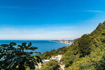 Wide landscape view of Black sea shore on sunny day from high altitude.
