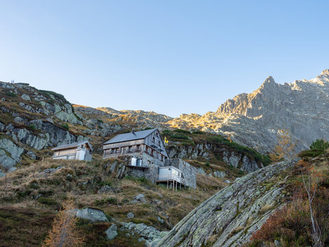 Windegg, Switzerland - October 17th 2022: A beautiful mountain hut in front of snow covered peaks