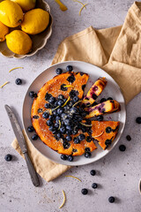 Sliced simple blueberry cake with lemons, top view on a plate 