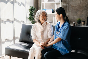Close up view of old woman leaning on nurse while siting.