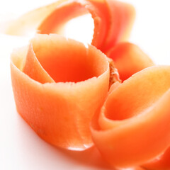 close up of orange carrot stripes on a white surface table