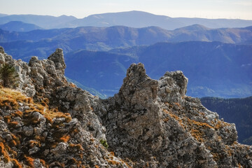 view through sharp rock into a valley with lot mountains