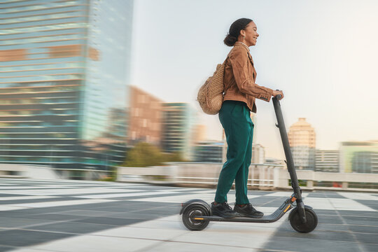 Electric Scooter, Travel And Black Woman With Eco Friendly Transport, Urban And Clean Carbon Footprint. Student On Commute Or Journey, Speed And Sustainability For Environment And Transportation.