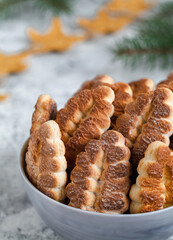 Grey bowl with tree shaped biscuits. Delicious Christmas bakery.