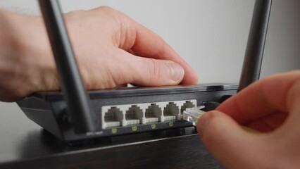 Man plugging in a WiFi router. Close up