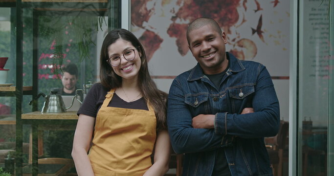 Two Happy Employees Of Local Small Business Shop. Young Diverse Millennials Entrepreneurs Posing Together At Camera With Arms Crossed