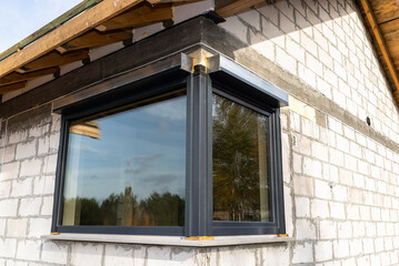Warm installation of a three-layer window with a polystyrene window sill, view from the outside.