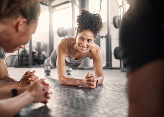 Happy black woman, group and plank in gym for health, fitness and wellness with strong core on...