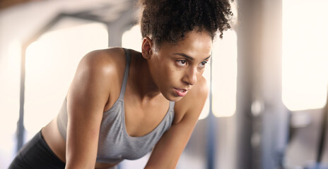 Gym, training and tired black woman breathing after exercise, workout and sports fitness. Woman in...