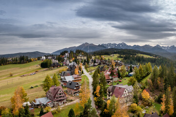 Bukowina Tatrzańska aerial autumn shot with Tatra Mountains in the background.