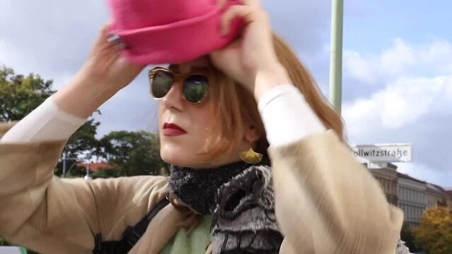 Woman putting on her hat