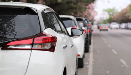 Closeup of rear, back side of white car parking beside the street.
