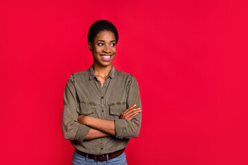 Portrait of attractive cheerful girl folded arms copy empty blank space ad isolated over bright red color background