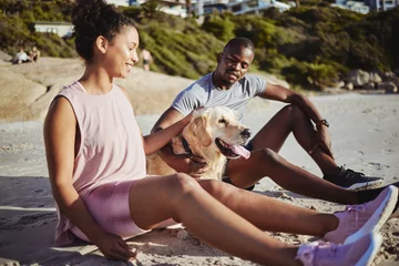 Fotobehang Relax, fitness and dog with black couple at beach after training for workout, health or exercise. Nature, peace and wellness with man and woman enjoy sunset with pet in sand for energy, happy or time © S Fanti/peopleimages.com