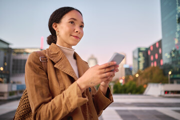 Phone, social media and city with a business black woman walking on a street or road on her evening commute. 5g mobile technology, communication and networking with a female employee in an urban town