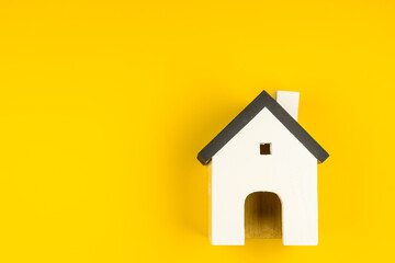 Miniature white toy house isolated on yellow colourful trendy modern fashion background. Mortgage property insurance dream home concept. Copy space - 545107974