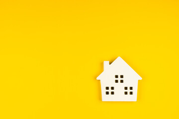 Fototapeta na wymiar Miniature white toy house isolated on yellow colourful trendy modern fashion background. Mortgage property insurance dream home concept. Copy space