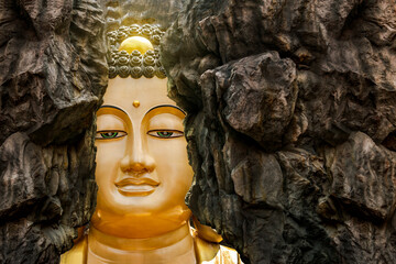 face of Buddha, big Buddha statue is hidden behind a cliff. Important landmarks of Samut Sakhon,...