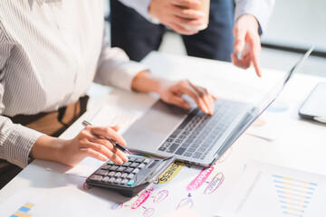 Group of business people meeting together Pointing to the graph assess business profits.