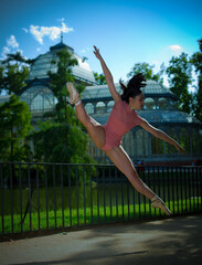 Beautiful ballerina dancing outdoors with body color cloth. She danced on ballet pointe shoes. 