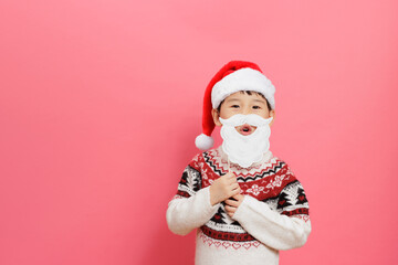 Fototapeta na wymiar Merry Christmas! Young girl celebrating Christmas against pink background