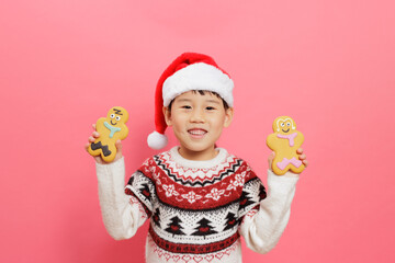 Merry Christmas! Young girl celebrating Christmas against pink background