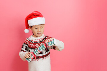 Merry Christmas! Young girl celebrating Christmas against pink background