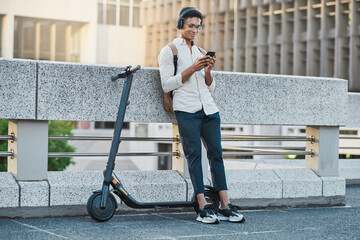 Phone, music and electric scooter with a business black man streaming audio during his commute into...
