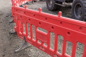 Red plastic construction fence at the construction site