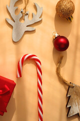 Small presents and various Christmas ornaments on neutral background. Top view.