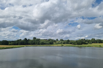View of a large lake and sky with large clouds.