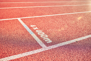 Sport, running track and stadium background for marathon, race and competition or fitness training for track and field athlete. Line, texture and path with nobody on rubber floor for fast run outdoor