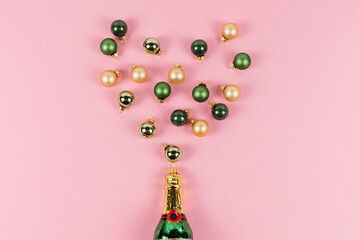 A Christmas tree bauble in the shape of a champagne bottle. Several Christmas tree balls come out...