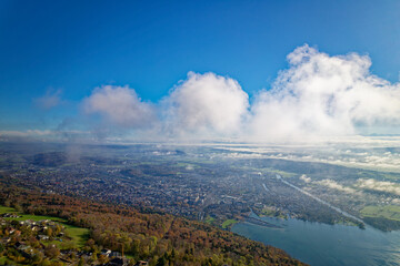 Fototapeta premium Aerial view from village Evilard, Canton Bern, over City of Biel Bienne and lake with Aaare River on a clue cloudy autumn day. Photo taken November 10th, 2022, Evilard, Switzerland.