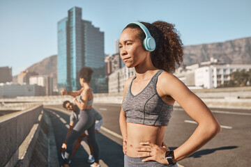 Music, fitness and black woman in city for running, exercise and sports, training and with friends outdoor. Podcast, runner and girl relax at workout on highway, listen to wellness, audio and mindset