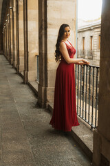 Caucasian woman in a red gala dress, portrait before going to the party or New Year's Eve