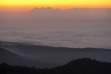 Landscape France Ardeche at Privas Creysseilles at dawn before sunrise with fog and clouds in the valleys
