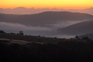 Landscape France Ardeche at Privas Creysseilles at dawn before sunrise with fog and clouds in the valleys