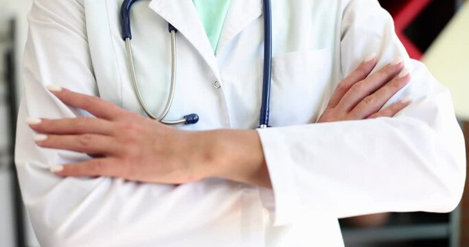 Confident female doctor therapist standing with arms crossed on chest closeup