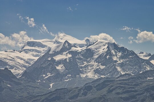 View Of The Snow-covered Mountaintop Under The Blue Sky