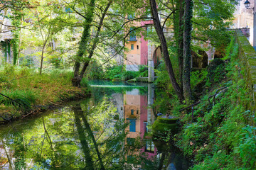 View of the Brugent river as it passes through the historic center of Sant Feliu de Pallerols, Garrotxa, Catalonia, Spain