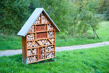 Fototapeta na wymiar Wooden insect hotel, habitat for bugs and bees, rescue house, environment and ecology conversation, protect wildlife 