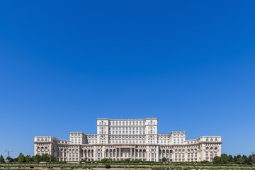 Fototapeta na wymiar Panorama of impressive Palace of the Parliament (Republic's House) is seat of Parliament of Romania, located atop Dealul Spirii in Bucharest, national capital, is the heaviest building in the world